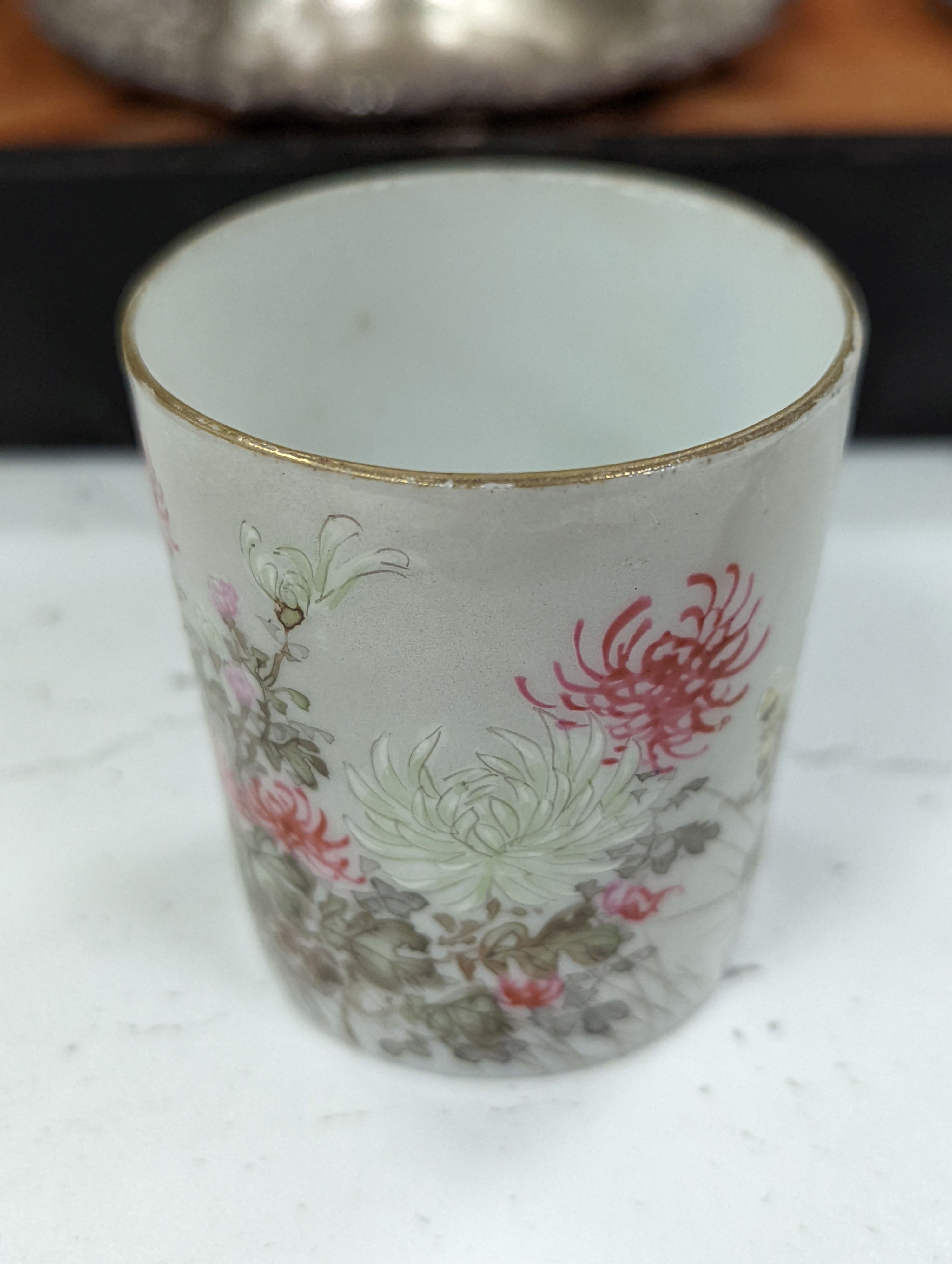 A cased Japanese white metal and eggshell porcelain six piece coffee set, maker’s mark only, case 39.5 cm wide